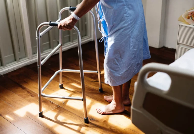 Older person using a walking frame at home