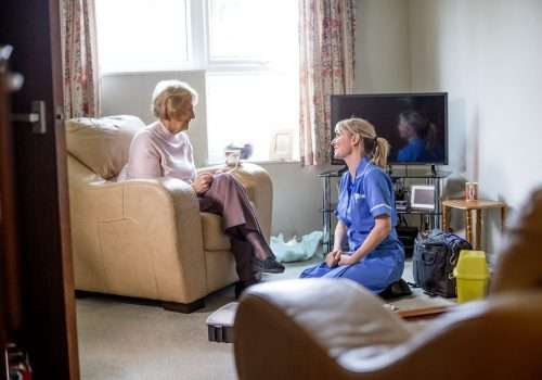 Carer visiting an older woman in her living room
